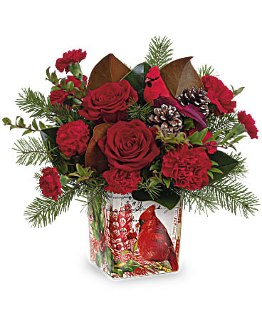 Red roses and carnations in a decorative vase with a cardinal design