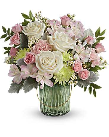 Pink and white flower arrangement in a glass vase