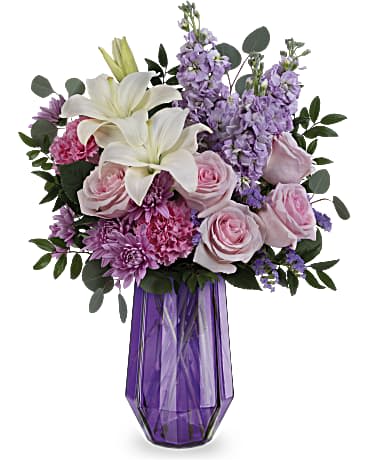 Bouquet of white lilies, pink roses, and purple flowers in a purple vase