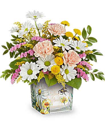 Mixed bouquet of daisies, carnations, and yellow filler flowers in a painted glass vase
