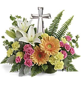 Bouquet of lilies, gerbera daisies, and pink roses with a silver cross