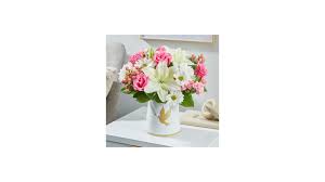 Whispers of Comfort - This keepsake ceramic vase with a dove pictured on the front is filled with the soft tones of pink roses, white mums and lilies, and filler to compliment the colors
