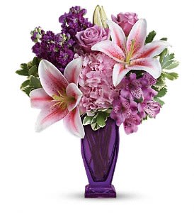 Teleflora's Blushing Violet Bouquet - This special bouquet features light pink hydrangea, lavender roses, pink stargazer lilies, purple alstroemeria, purple stock, and variegated pittosporum. Delivered in a violet Couture vase. Approximately 15 W x 18 H