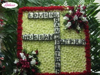 Floral tribute with the words Loving Husband Father