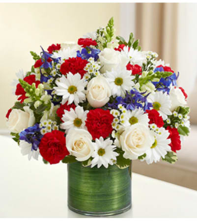 Red, White &amp; Blue  - A patriotic arrangement with all white, red &amp; blue assorted flowers arranged in a short clear glass vase shows your love of America. 