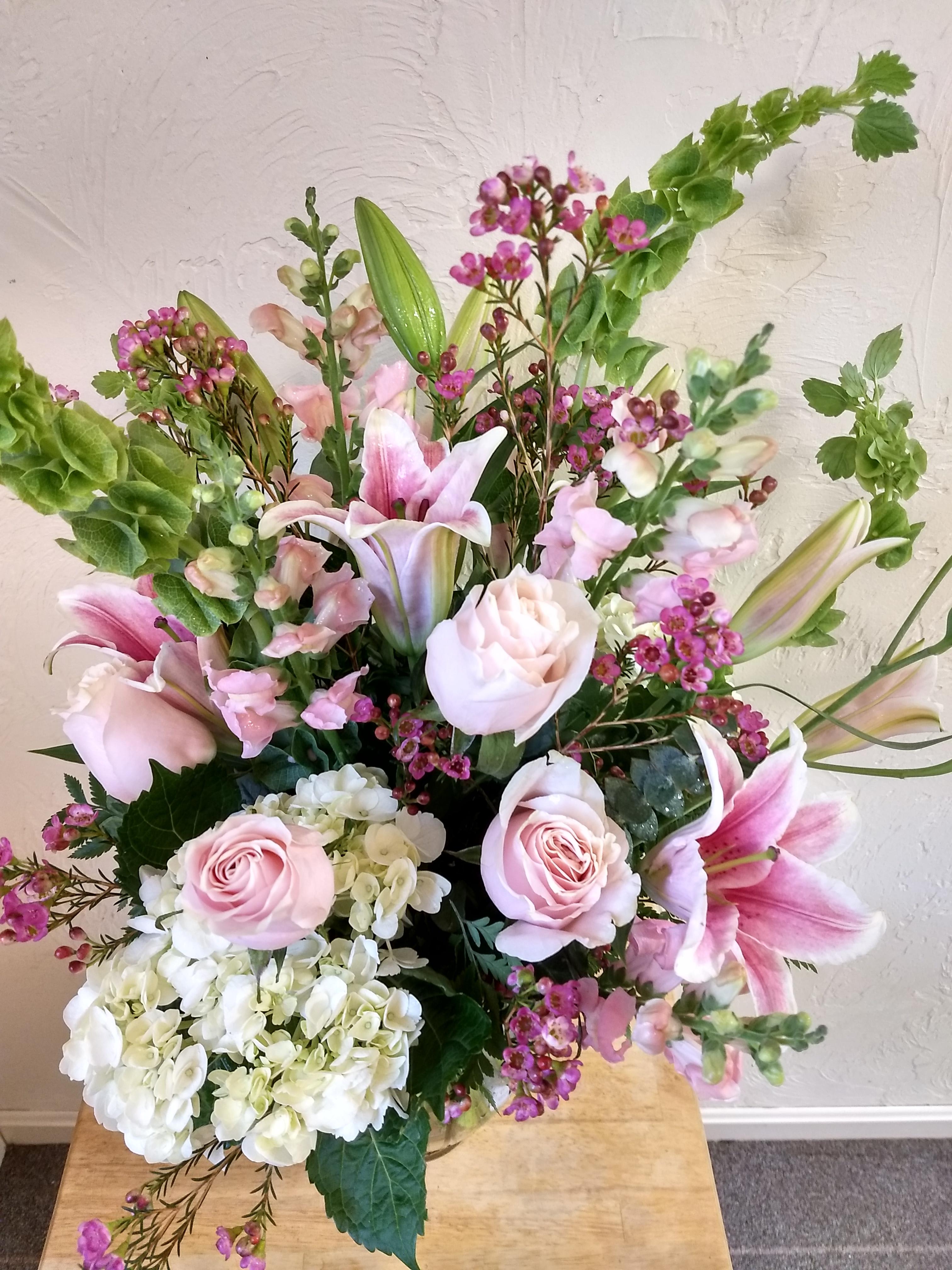 Pink roses, lilies, and white hydrangeas in a mixed bouquet