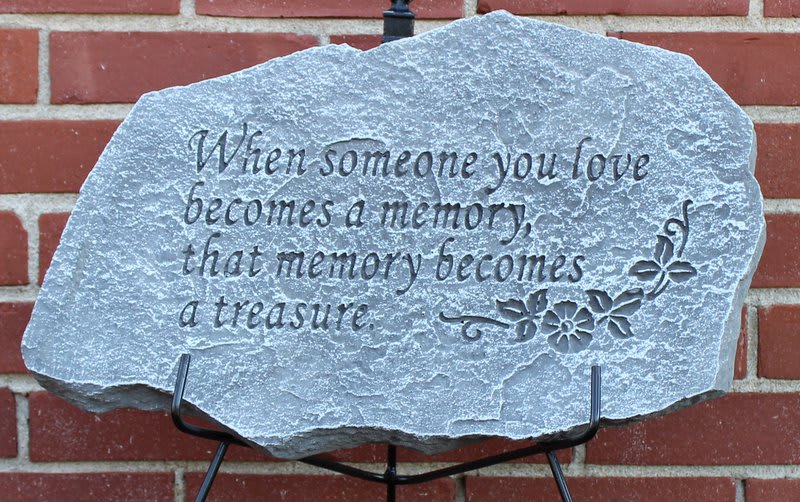 Engraved memorial stone with a sympathy quote on a stand