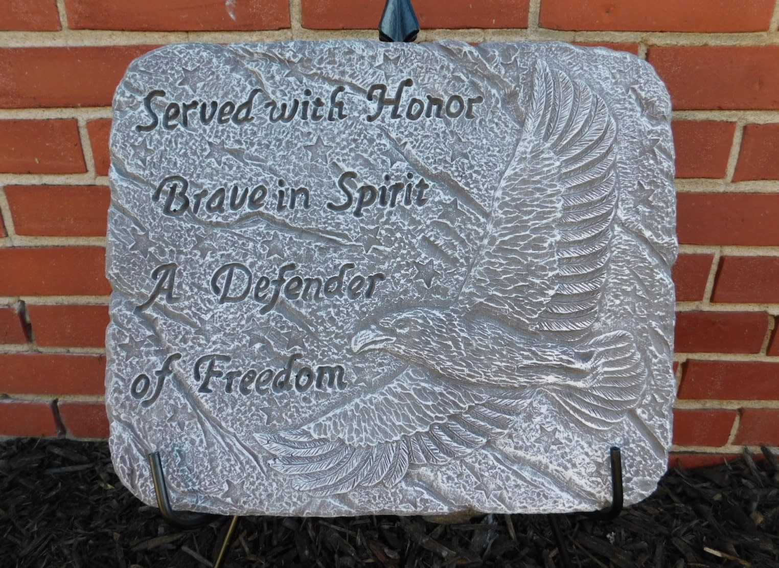 Memorial stone plaque with an eagle relief and engraved text