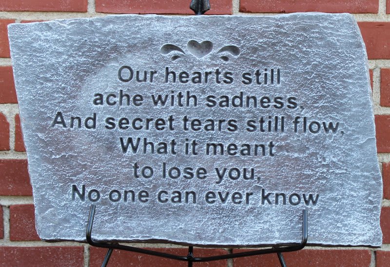 Stone memorial plaque with a sympathy poem on a stand