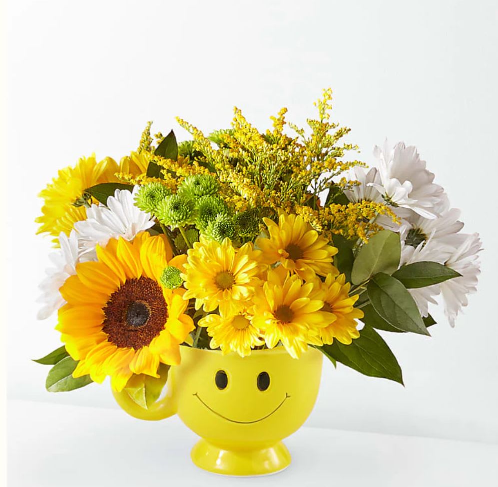 Joyful Smiles Bouquet  - Designed by florists, ready to display. For long–lasting blooms, replace the water daily. We suggest trimming the stems every couple days. The image used is at the deluxe price range. The flowers may vary, but the smile mug will stay consistent. 