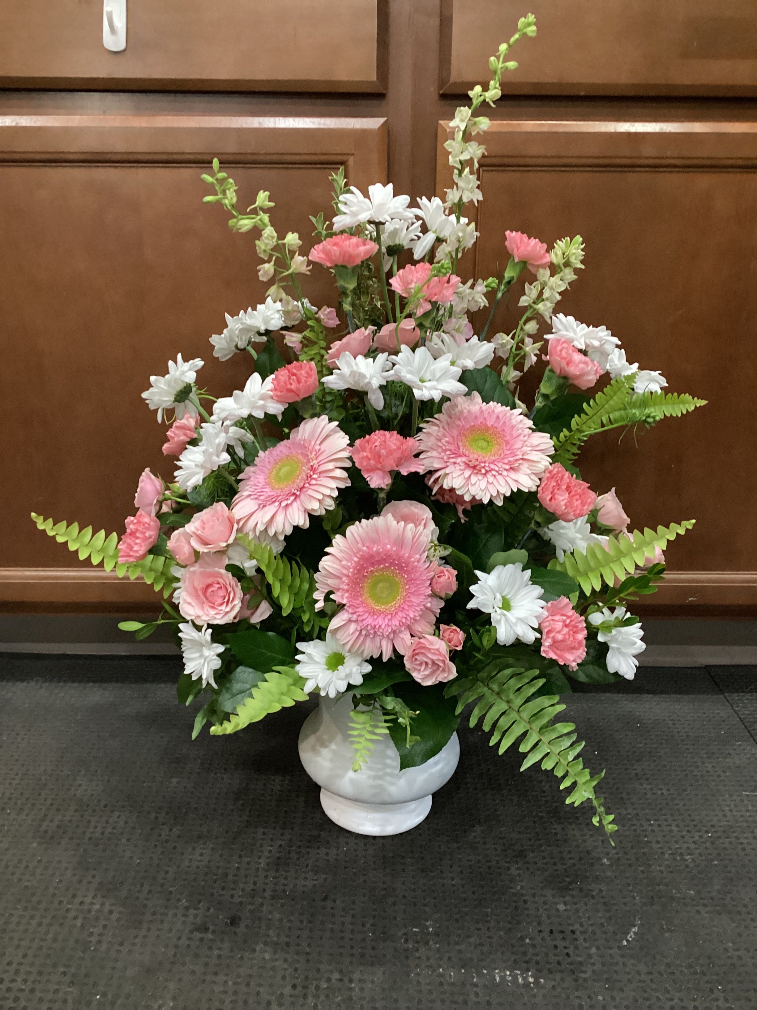 Pink and white mixed flower arrangement in a white vase