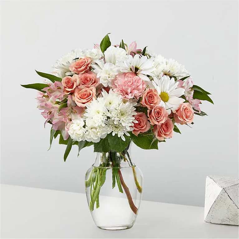 Pink and white mixed bouquet in a clear glass vase
