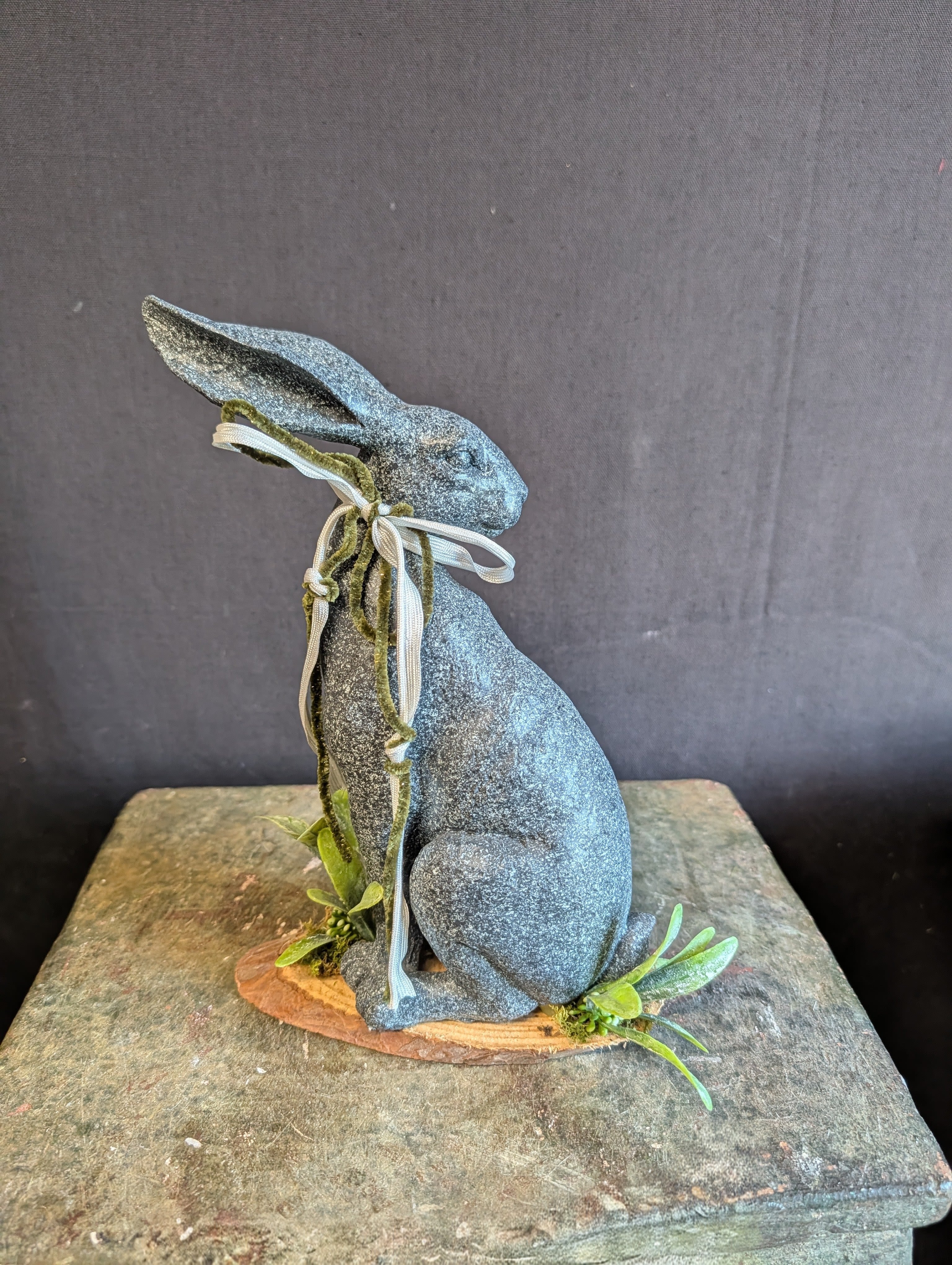 Graphite Bunny - A grafite rabbit figurine on a natural wood riser makes this decorative gift feel both whimsical and quietly sophisticated - perfect as a table accent or a charming springtime gift. This gift suits someone who loves rustic, modern decor and unexpected textures; it's the kind of gift that will make the person you're thinking of smile every time they spot it on a mantel or entry table.  Give this to a friend, mom, or host who appreciates seasonal touches and lasting decor  - it's an easy way to mark spring or a housewarming with personality.
