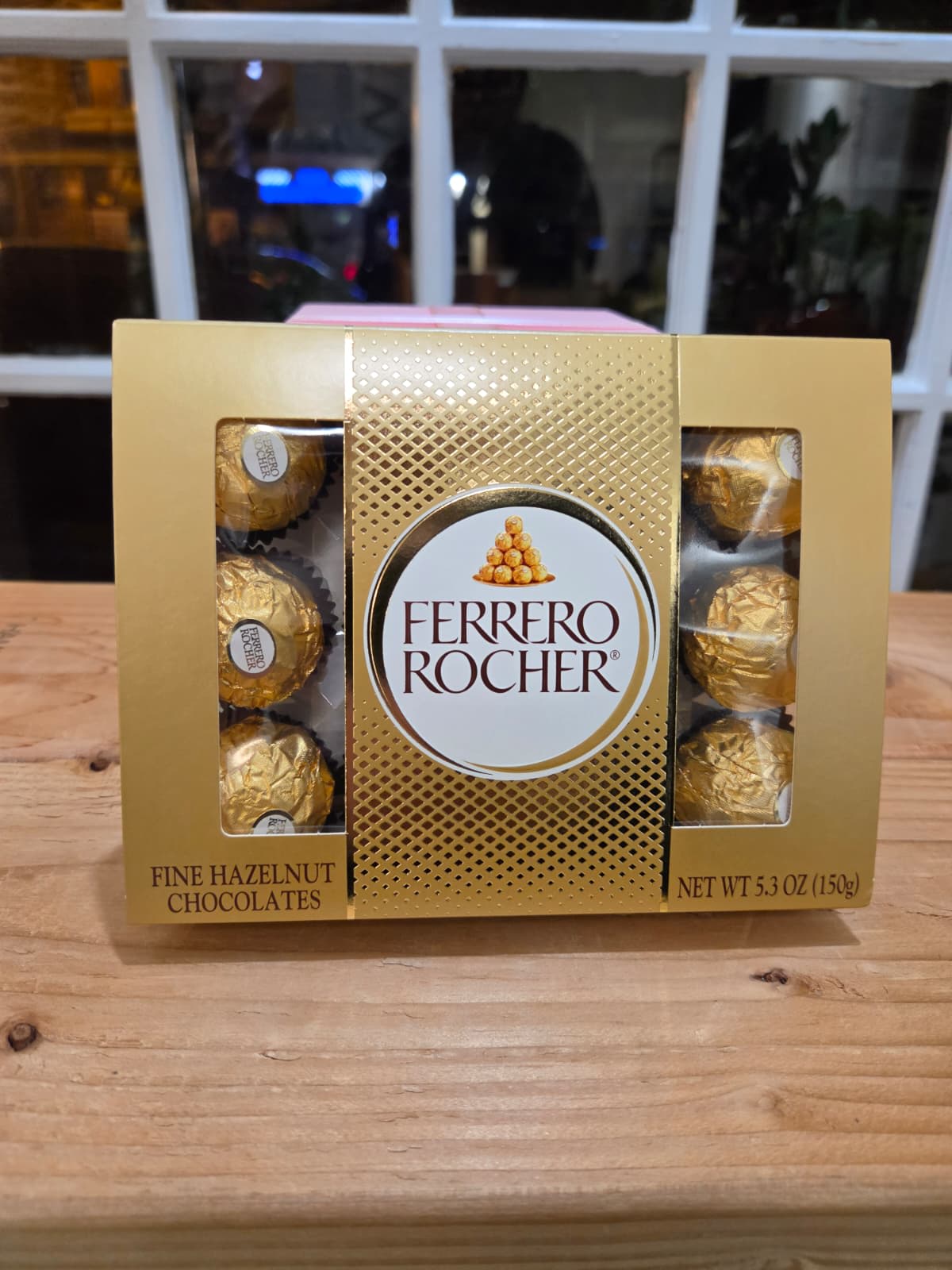 Box of Ferrero Rocher chocolates on a wooden table