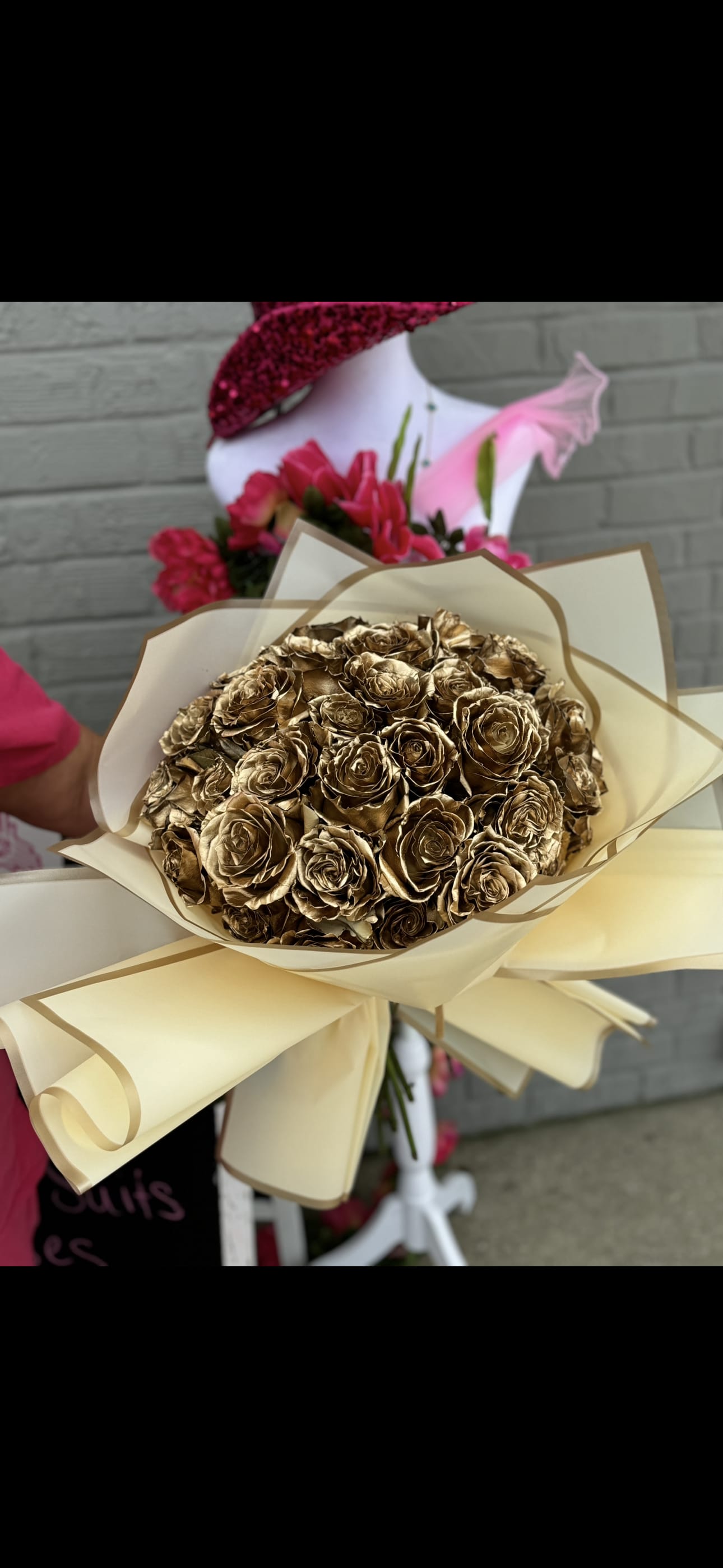 Bouquet of metallic gold roses wrapped in cream paper