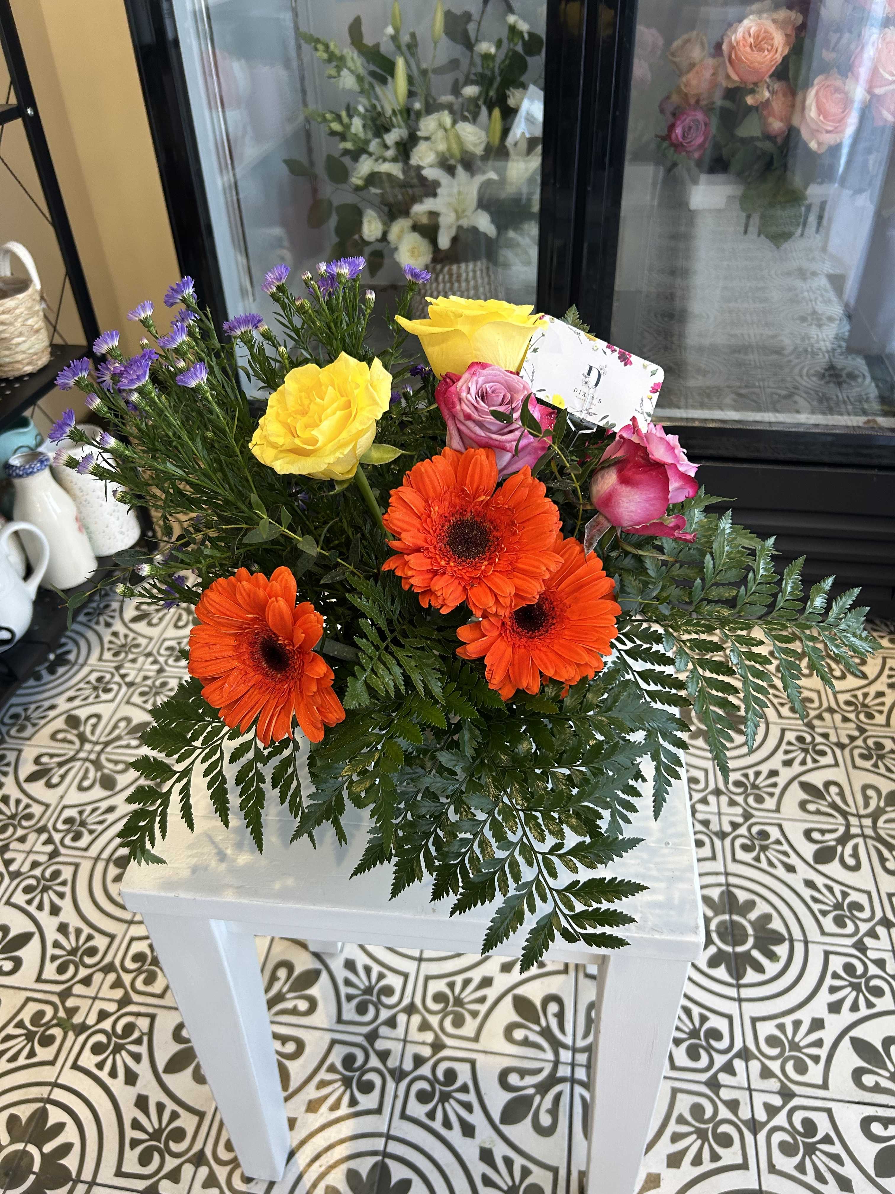 Bouquet of orange gerbera daisies and pink and yellow roses