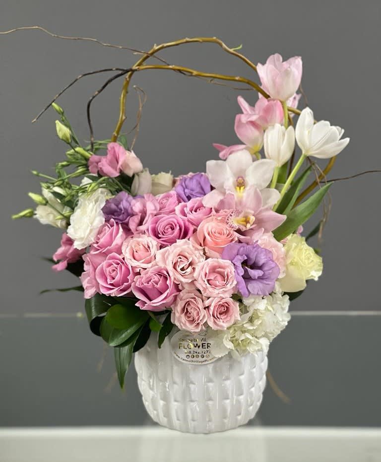 Pink and white floral arrangement in a white vase