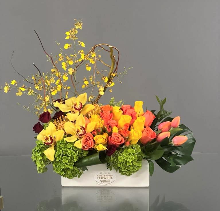 Bright mixed floral arrangement in a white rectangular box