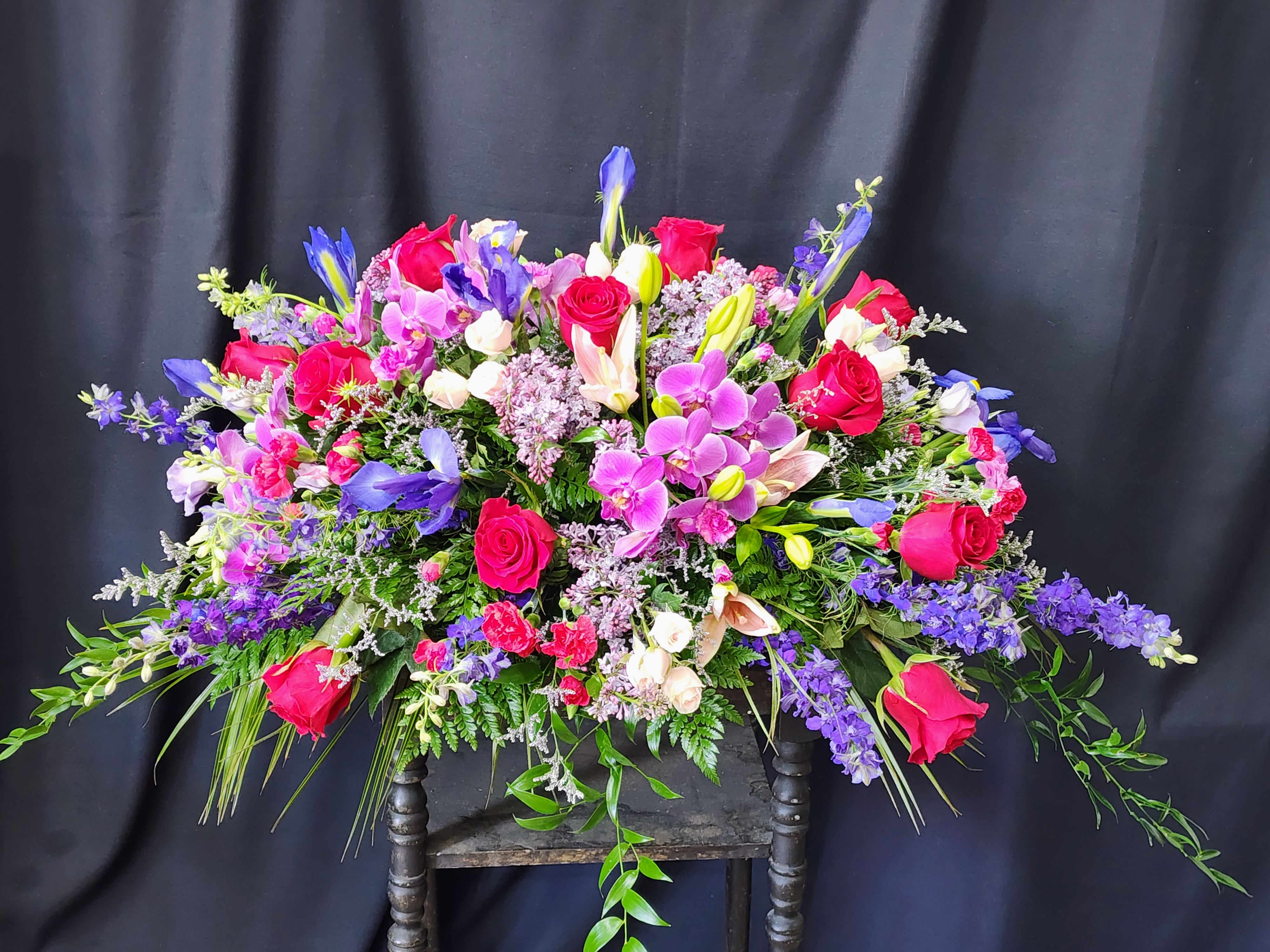 Large mixed bouquet of pink roses, purple orchids, and lilies
