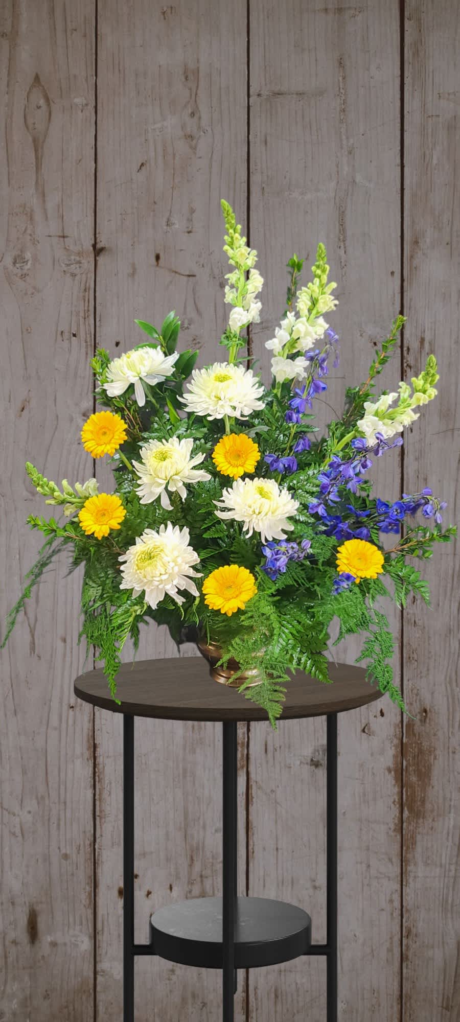 Mixed bouquet with white and yellow flowers in a bronze vase