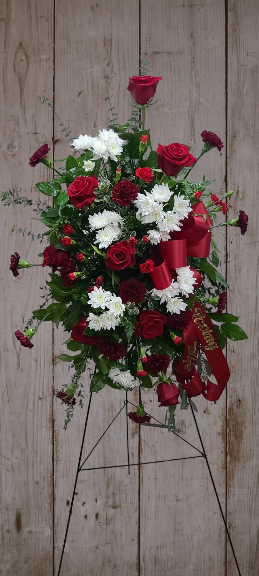 Standing floral spray with red roses, white chrysanthemums, and burgundy carnations