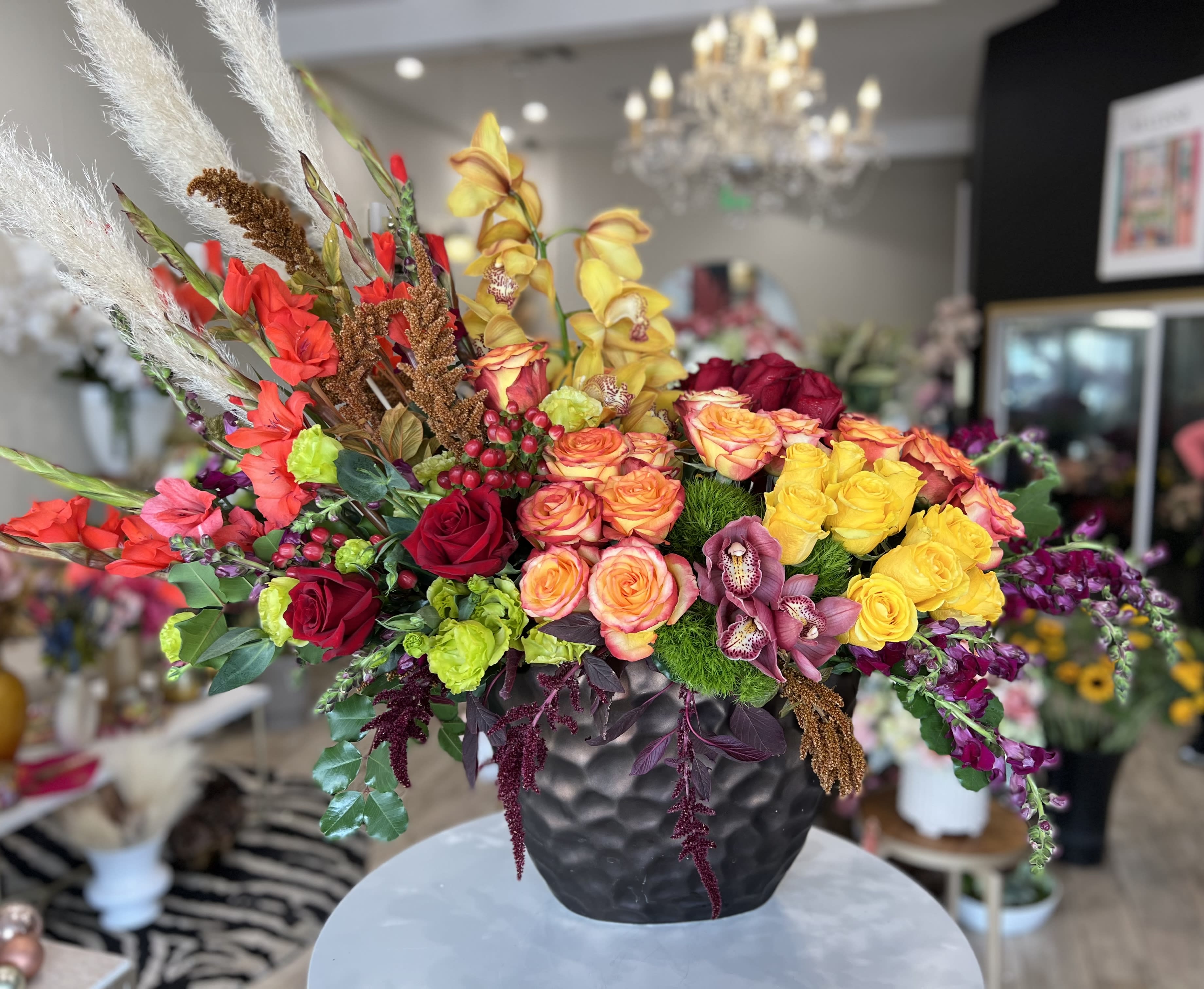 Colorful mixed flower arrangement in a black vase