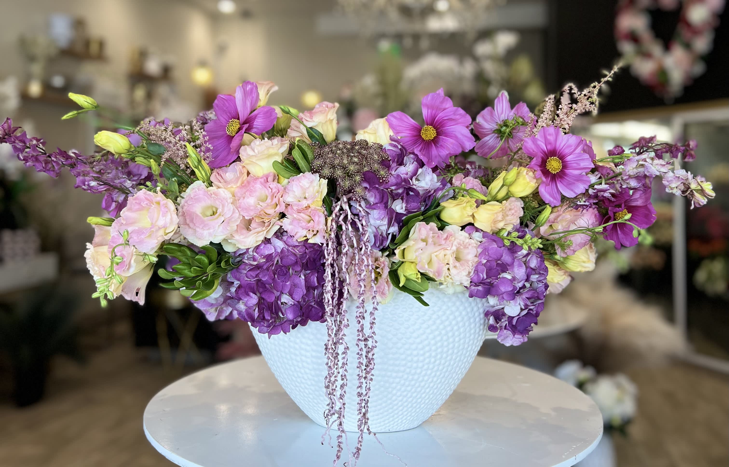 Lavender and pink mixed bouquet in a white textured vase
