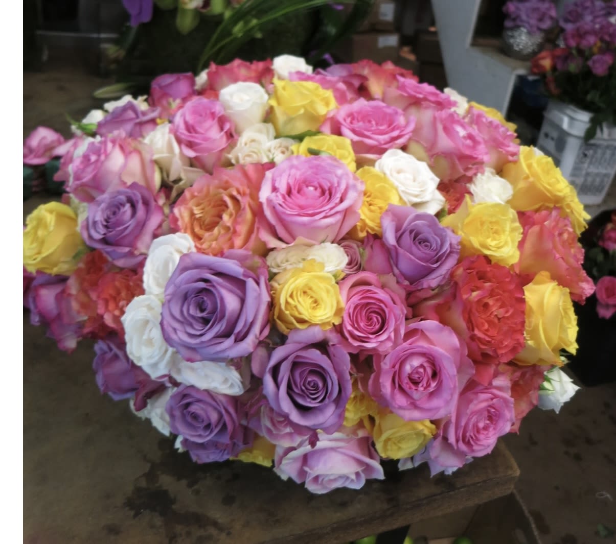 Large bouquet of multicolored roses in pink, purple, white, and yellow