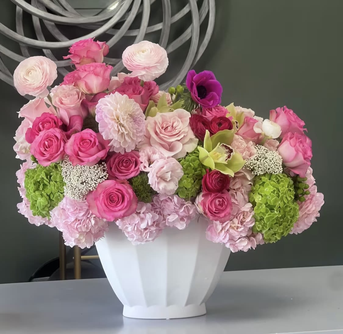Pink and white floral arrangement in a white vase