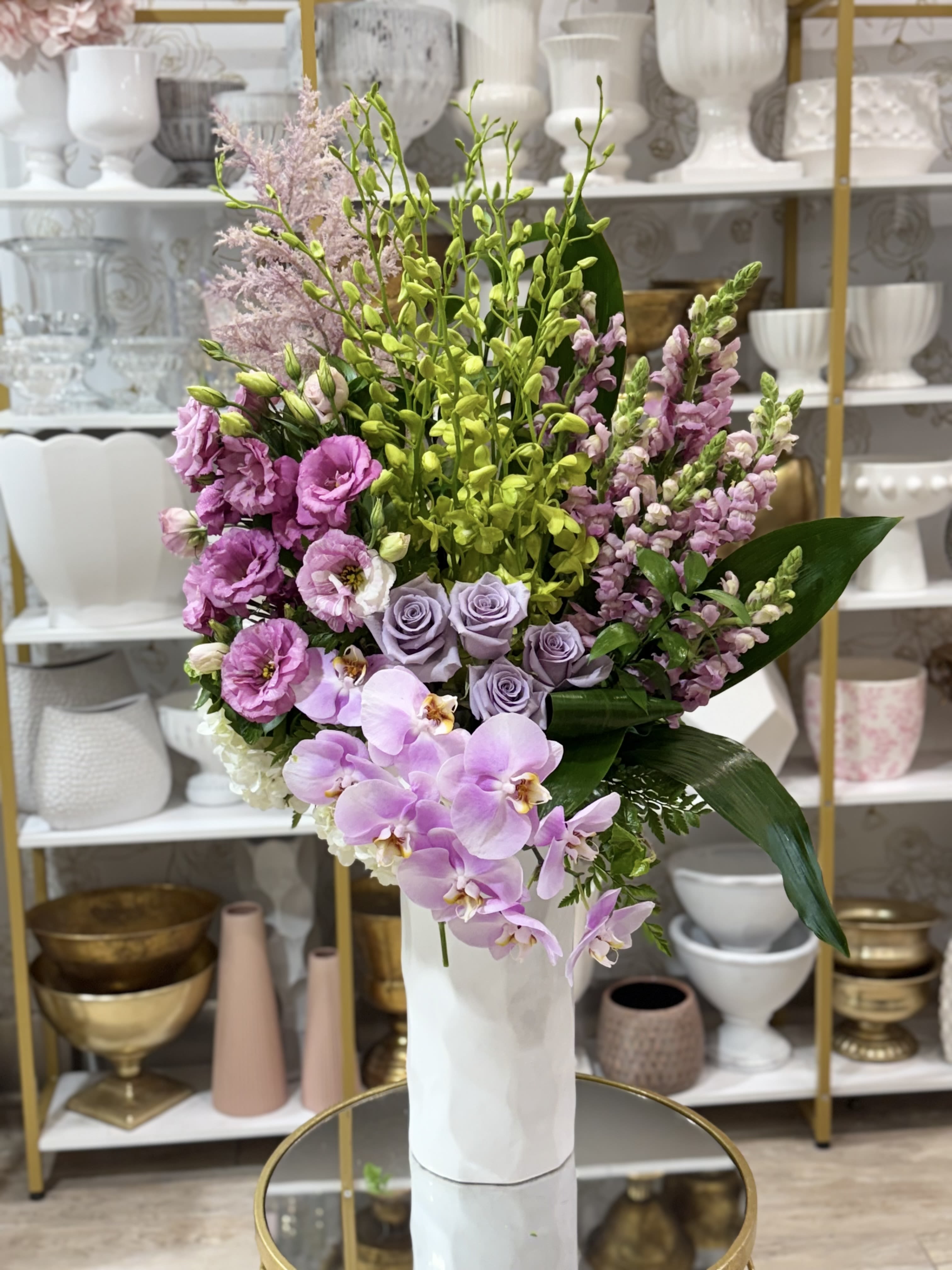 Lavender and pink floral arrangement in a white vase