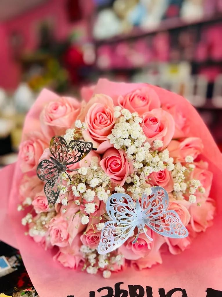 Pink Rose Bouquet - 2 dozen pink roses (wrapped in paper )with baby breath and butterflies.