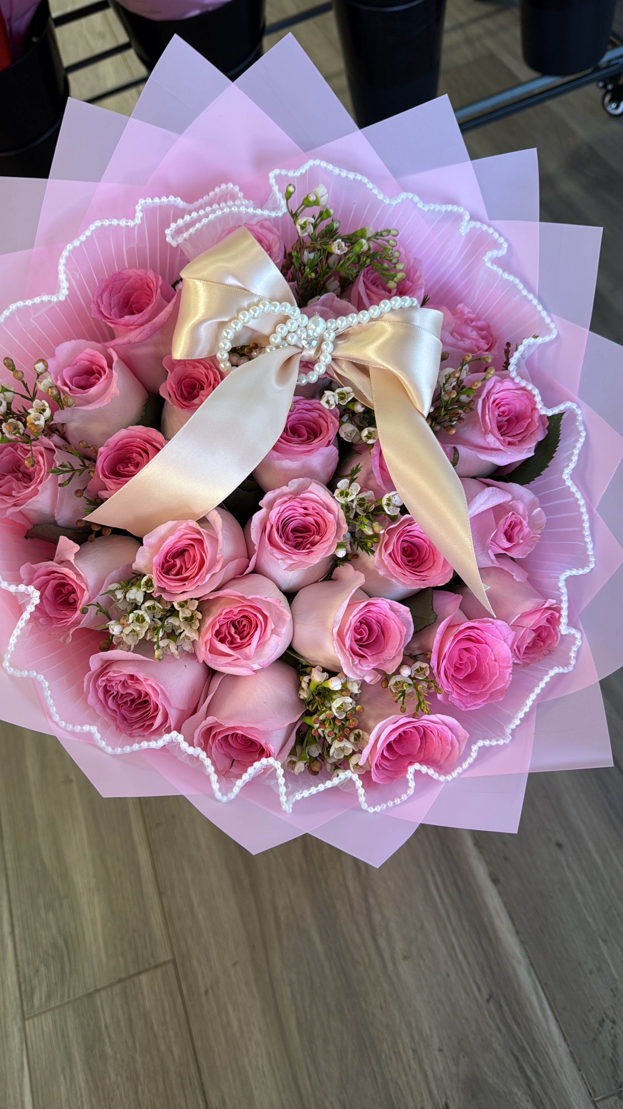 Pink rose bouquet with a satin bow and pearl accents