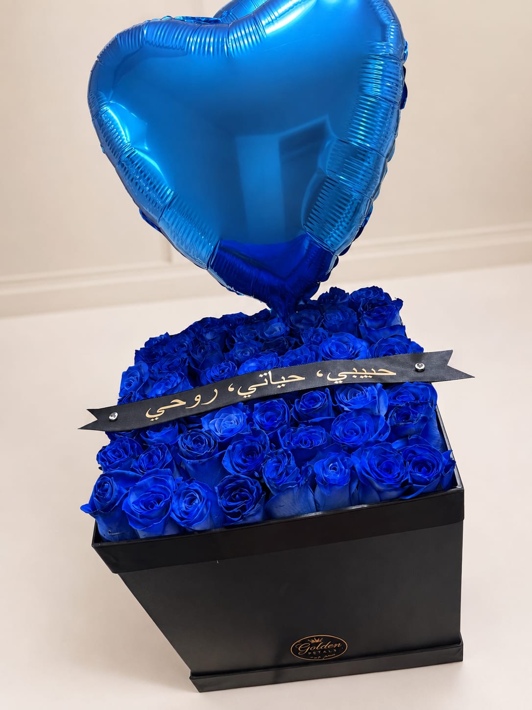 Blue roses in a black box with a blue heart balloon