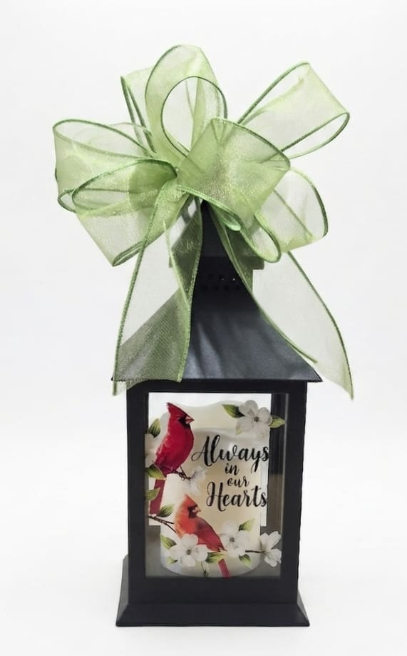 Black lantern with a green bow and a memorial bird design