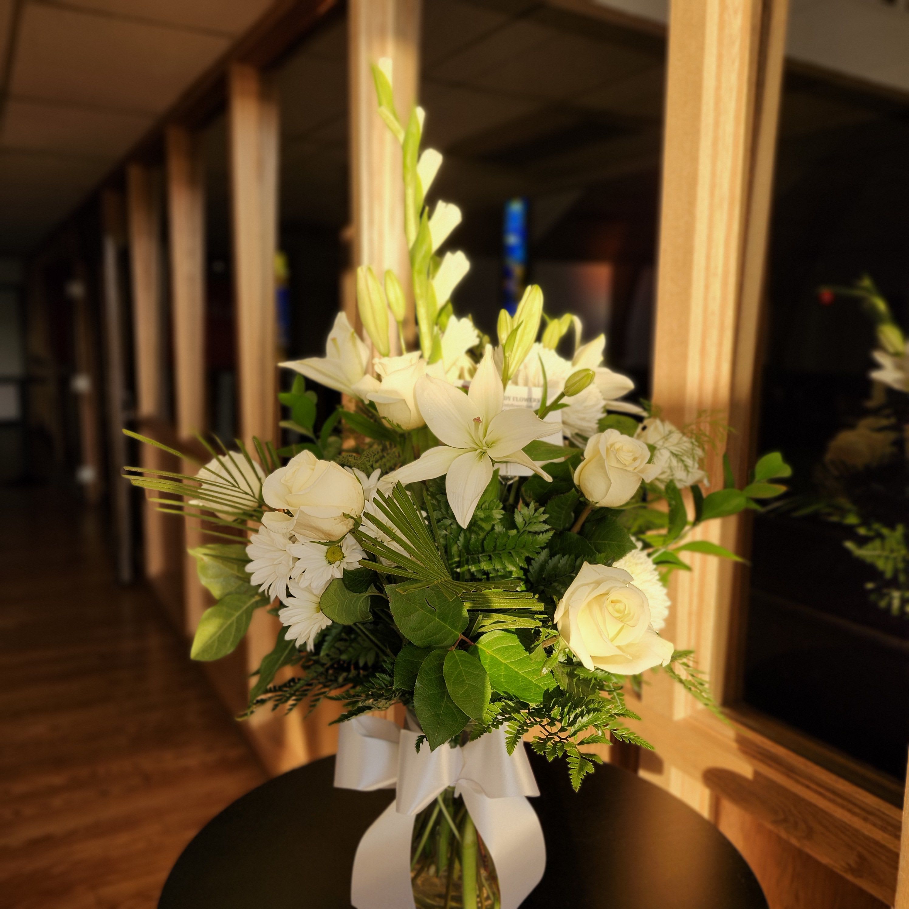 Forever in our Hearts - Express your deepest condolences with this bouquet of lilies, roses, gladiolus, and daisies. This beautiful bouquet is sent with heartfelt sympathy. May the delicate lilies, classic roses, vibrant gladiolus, and cheerful daisies offer a small token of comfort. 