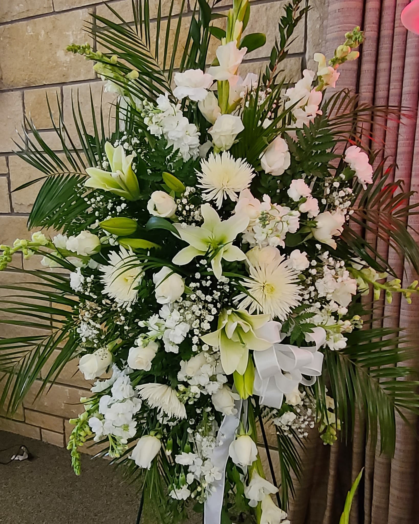 Sincerest Condolences Standing Spray - An all white sympathy standing spray with premium flowers. 