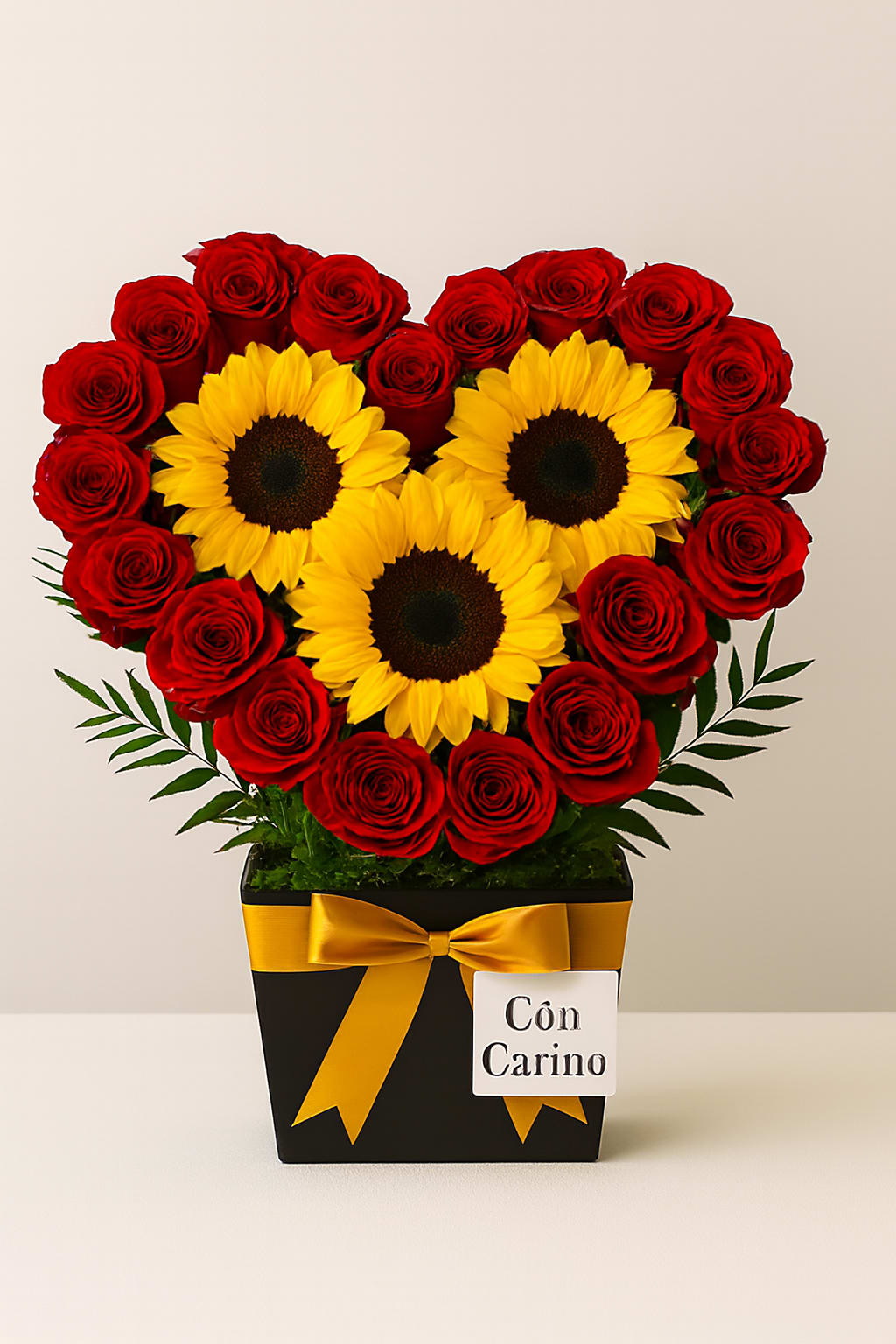 Corazón del Sol by Latin Lady Tradicional - Un corazón floral vibrante y lleno de vida, diseñado con rosas rojas frescas y tres girasoles que iluminan el centro del arreglo. La combinación del rojo intenso con el dorado del girasol crea un contraste cálido, alegre y significativo — perfecto para expresar cariño, gratitud o admiración.  A vibrant, lively floral heart designed with fresh red roses and three sunflowers that brighten the center of the arrangement. The rich red roses paired with the golden sunflowers create a warm, joyful, and meaningful contrast — perfect for expressing affection, gratitude, or admiration.   