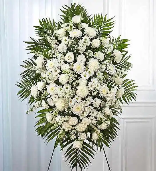White Funeral Standing Spray - White flowers have a peacefulness and purity to them, bringing hope and light during a time of loss. Our impressive standing spray arrangement is meticulously handcrafted by expert local florists with an abundance of pristine white blooms for a lush, full presentation. Let it be a grand and memorable tribute to one who was loved so dearly. 