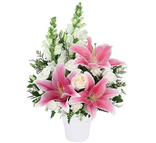 Pink lilies and white roses in a white vase
