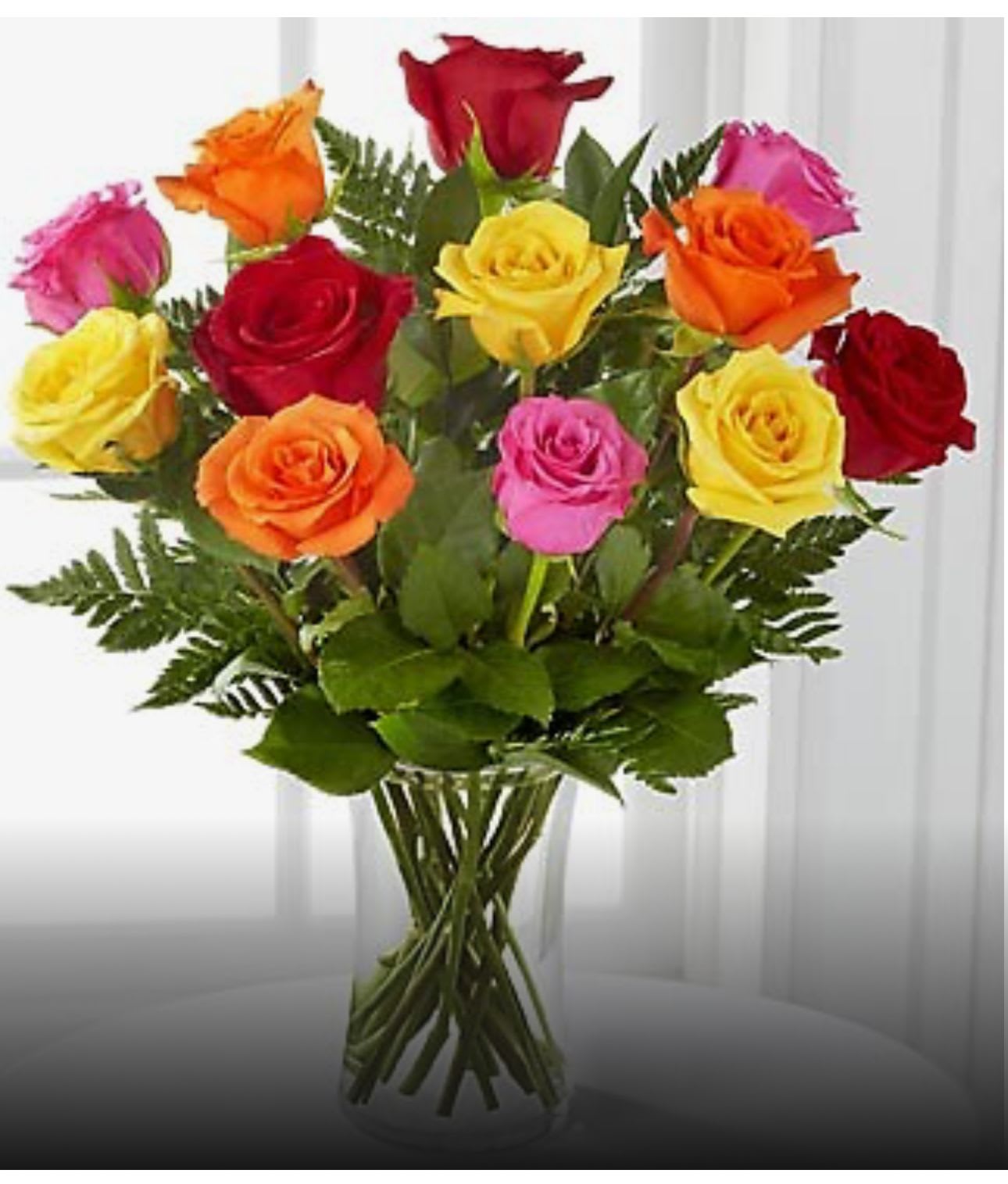 Mixed-color roses in a clear glass vase