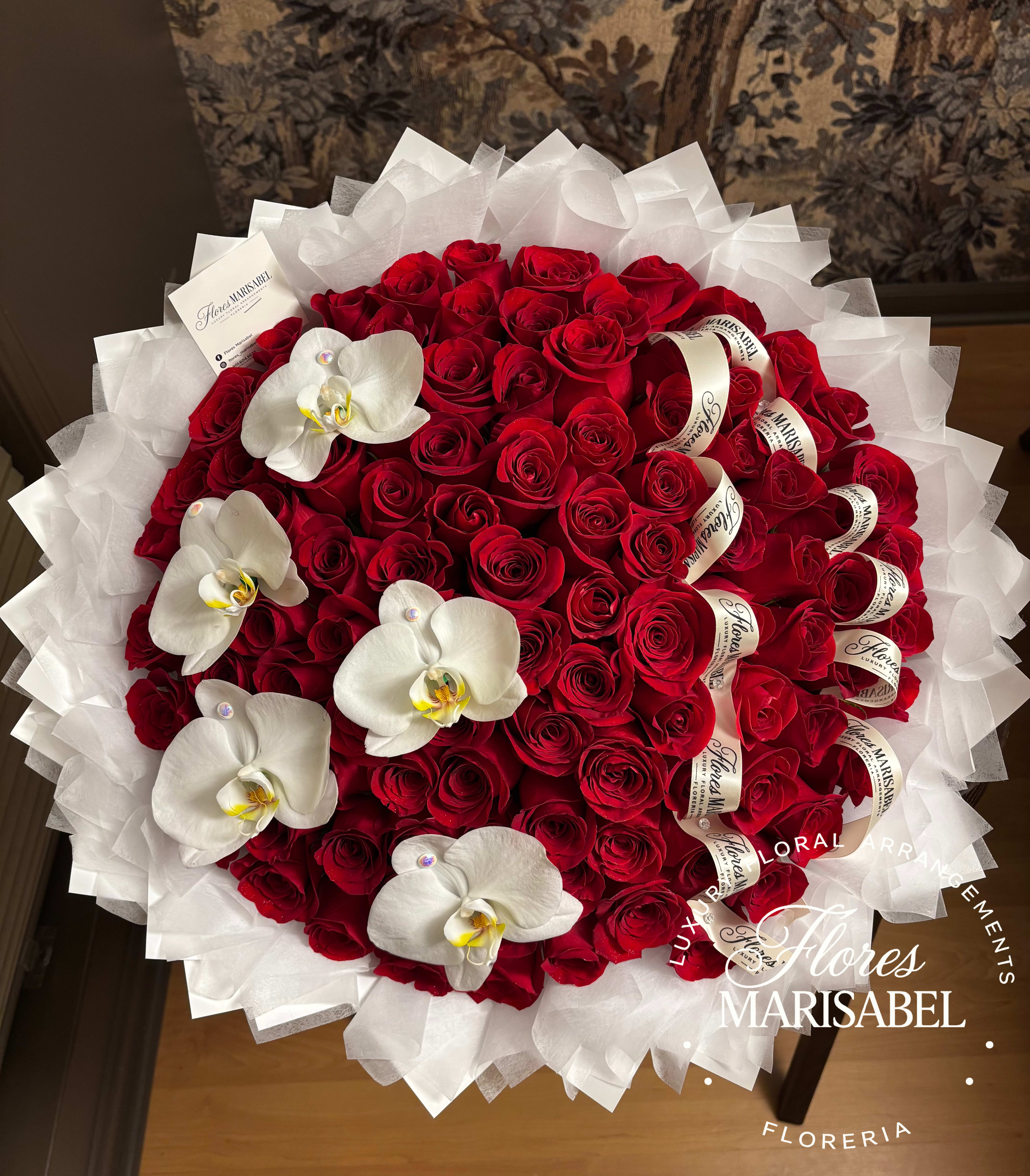 Large bouquet of red roses with white orchids and white wrapping
