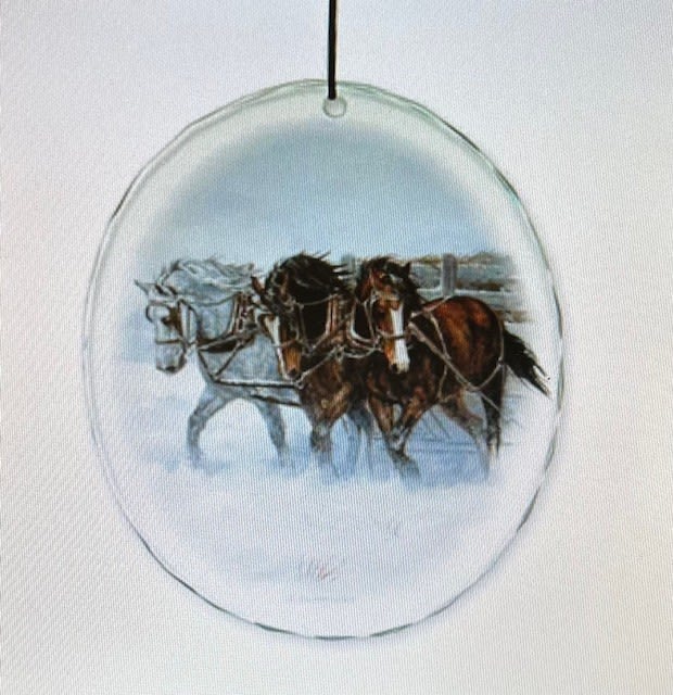 Round glass ornament with a painted horse scene