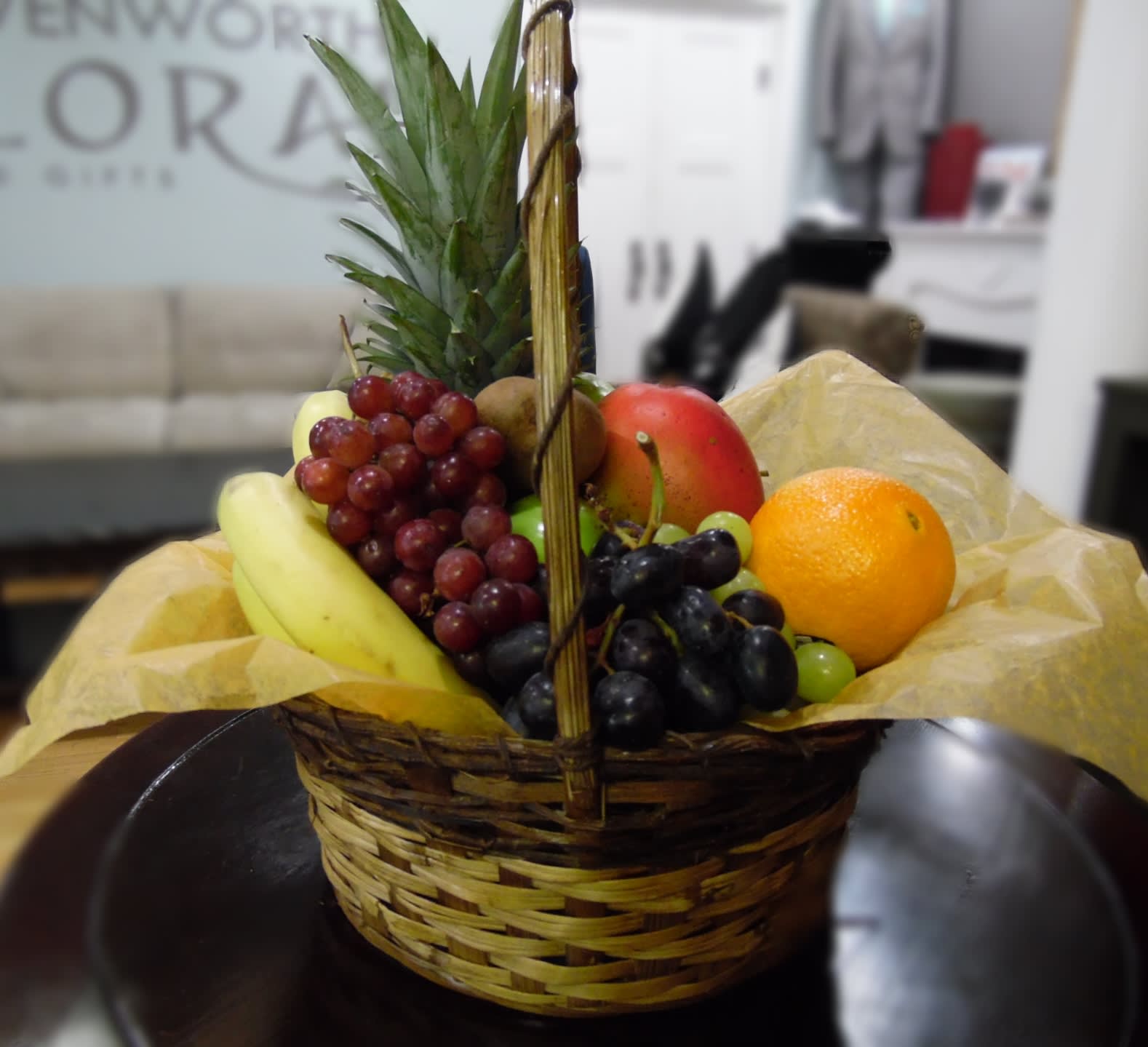 Basket of assorted fruit with a pineapple centerpiece