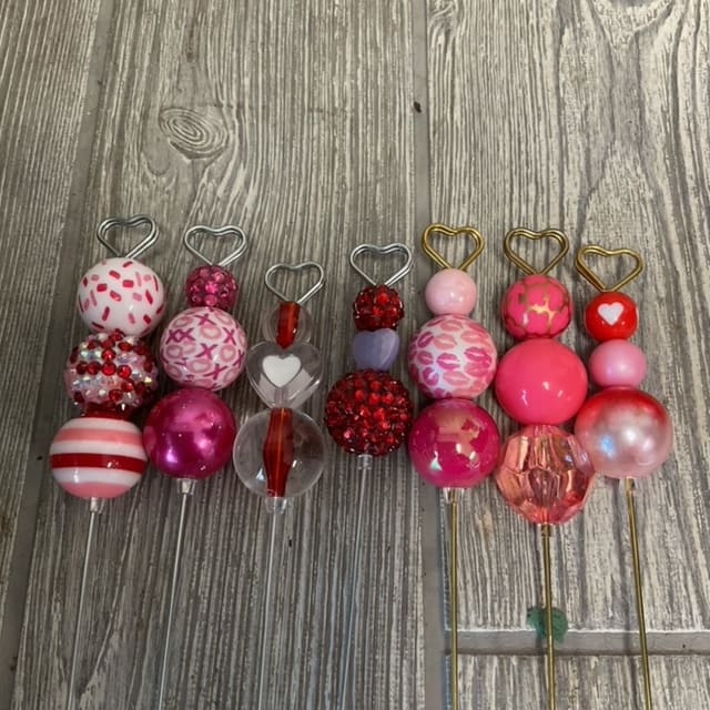 Decorative heart-topped picks with colorful beaded and patterned spheres