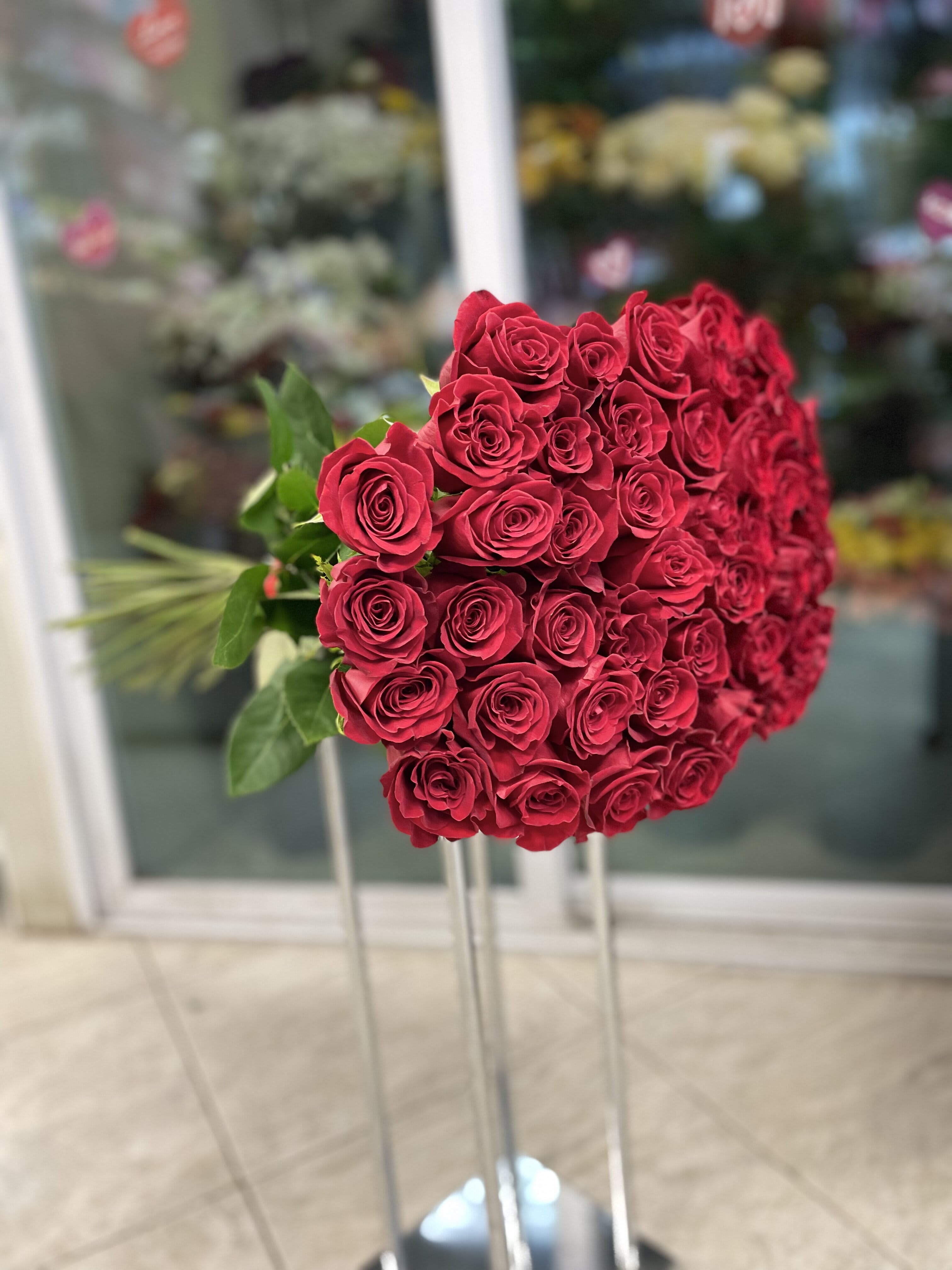 Large bouquet of red roses on tall stands