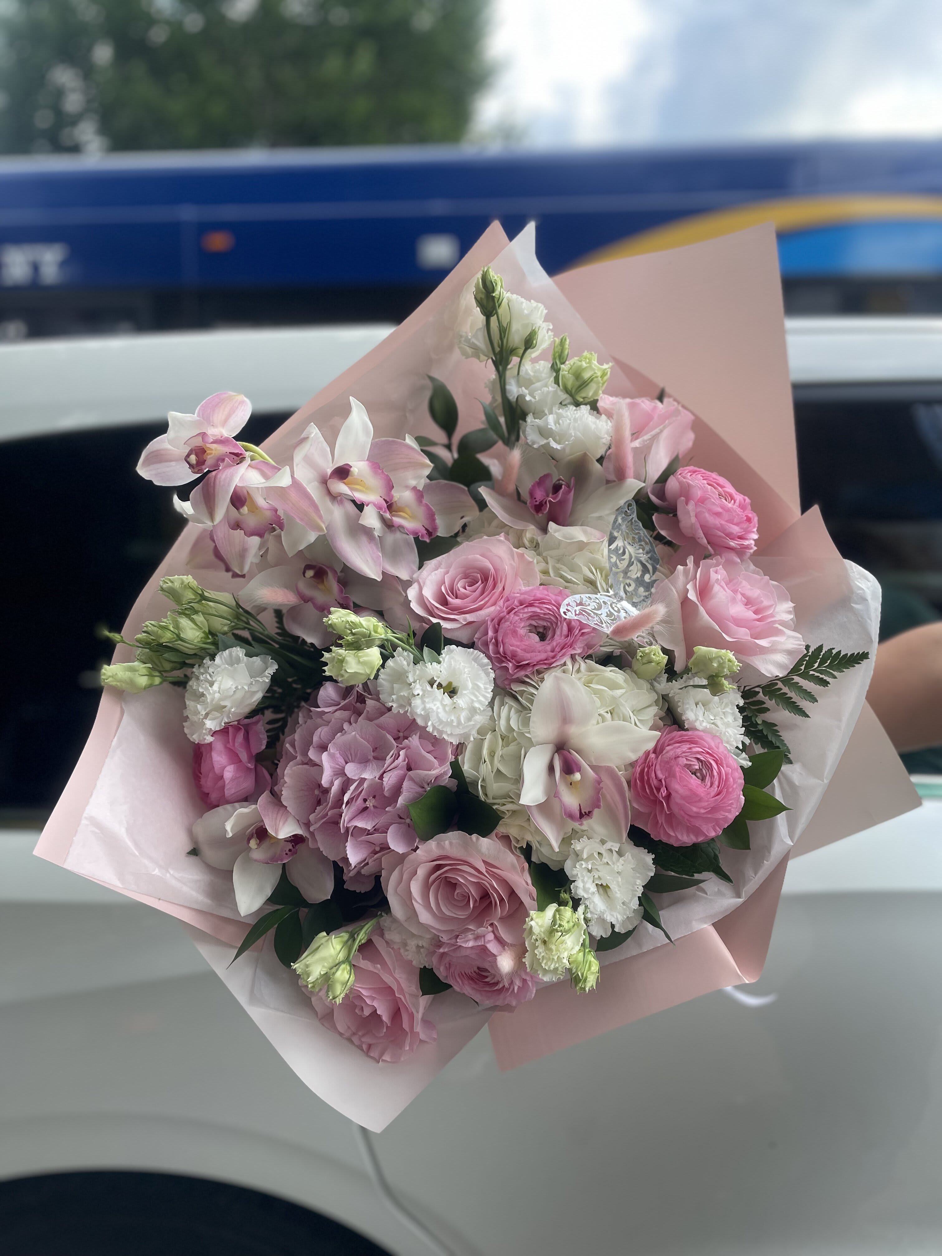 Pink and white mixed bouquet wrapped in pale pink paper