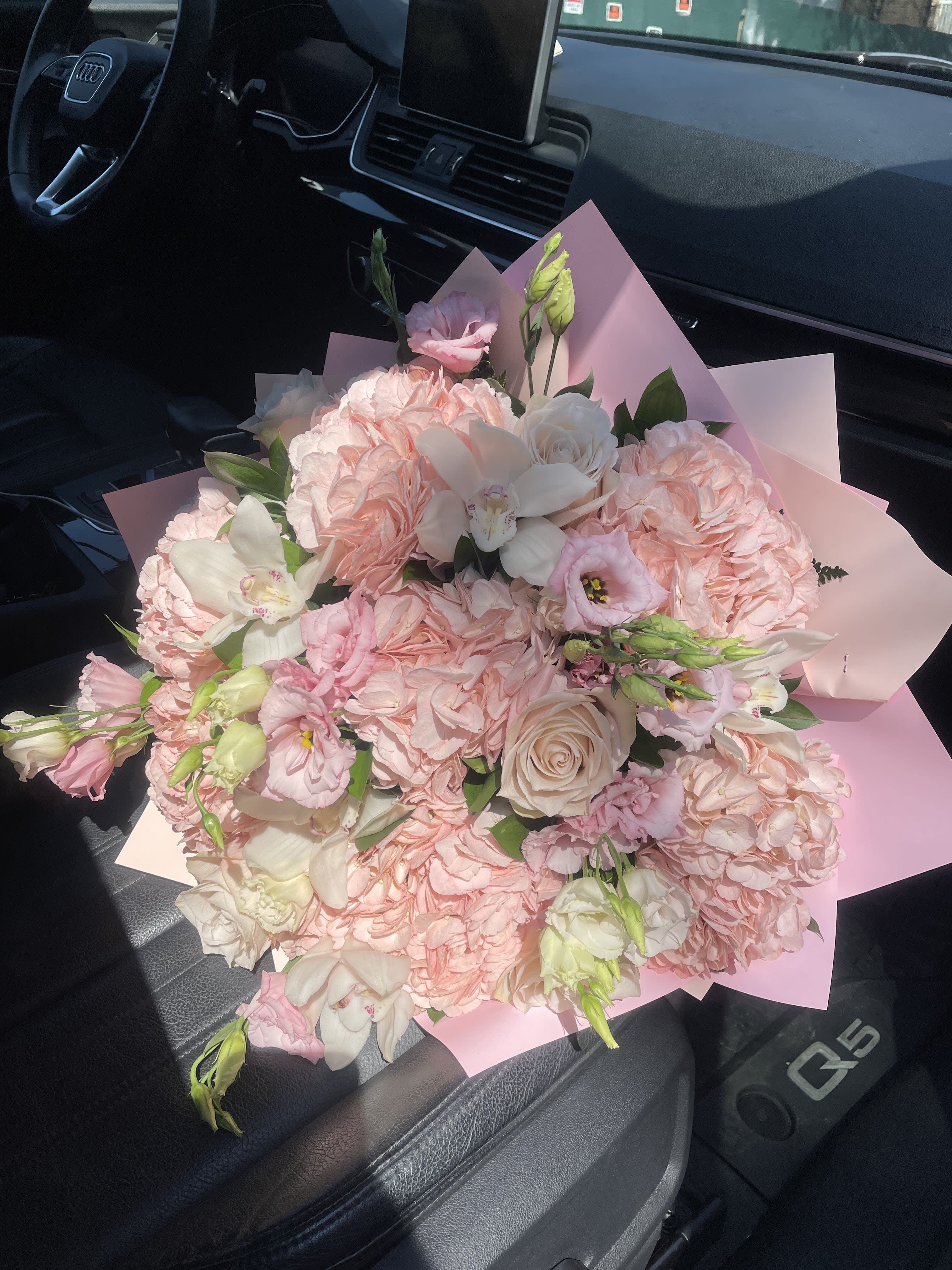 Pink and white bouquet with roses and lisianthus wrapped in pastel paper