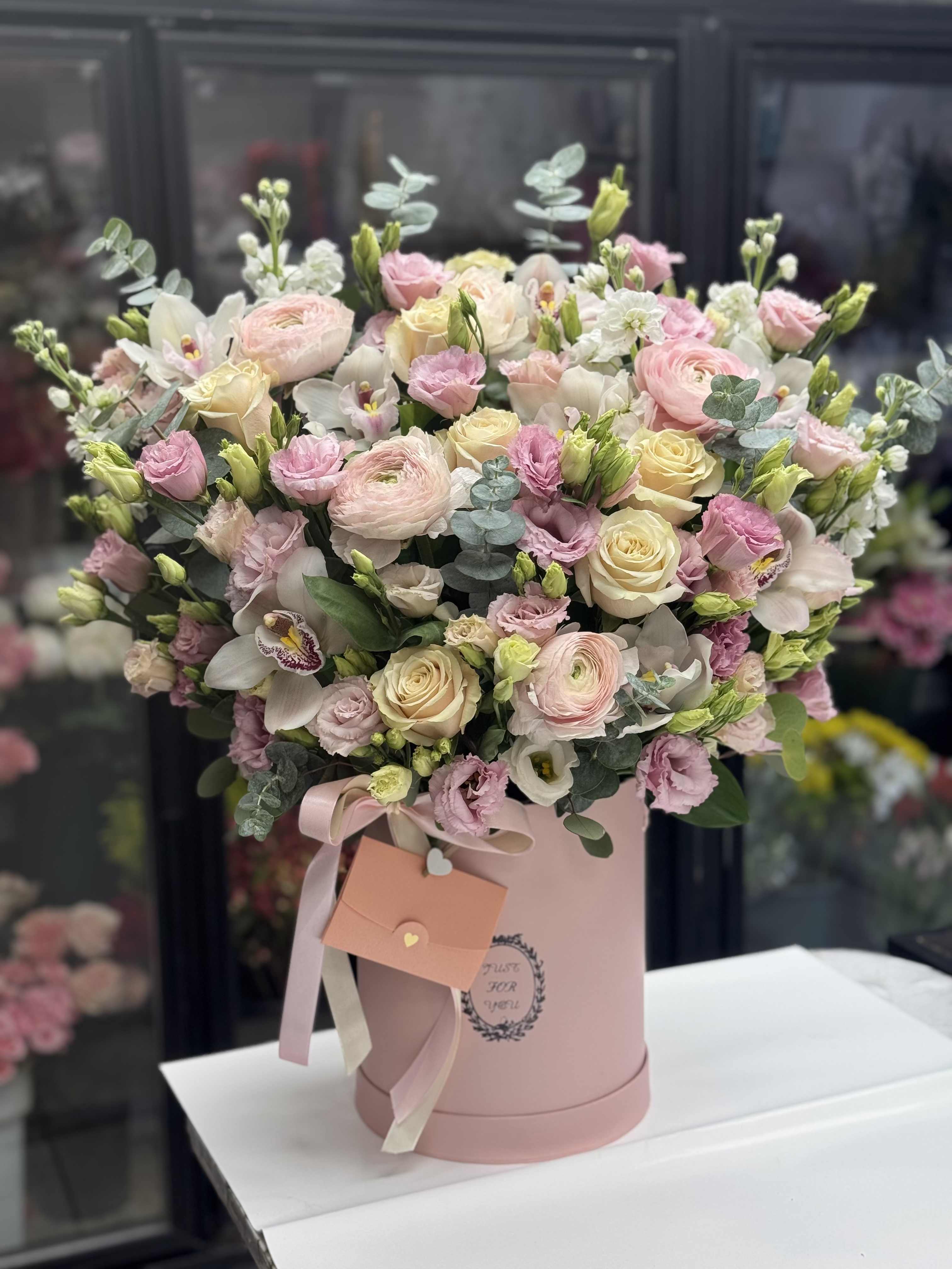Pink and cream bouquet in a round pink box with ribbon