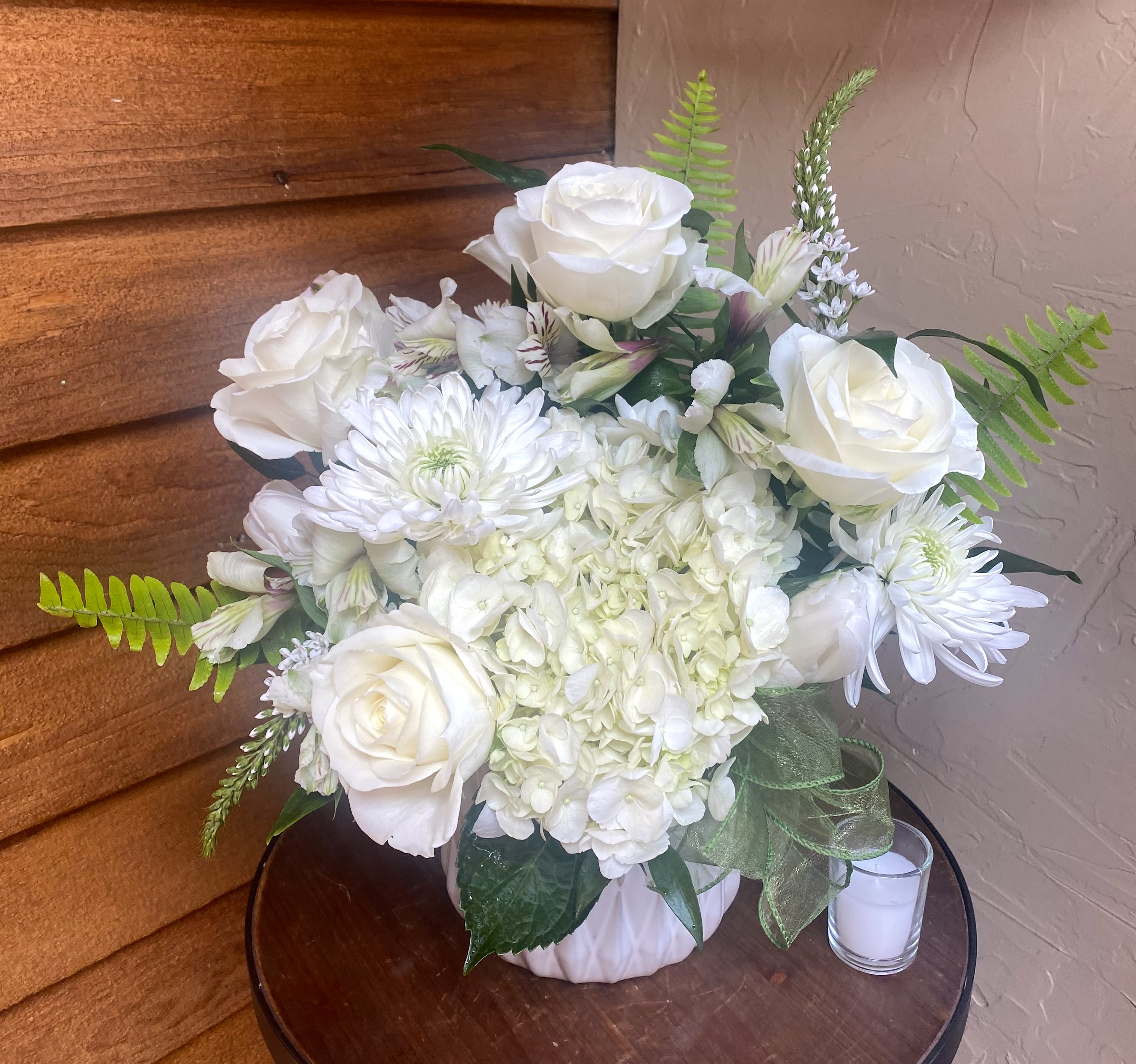 Innocence - Variety of specialty white flowers and greens in a keepsake container~Designer's choice on freshest seasonal flowers and container choice.