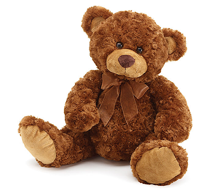 Brown teddy bear with a ribbon bow sitting on a white background